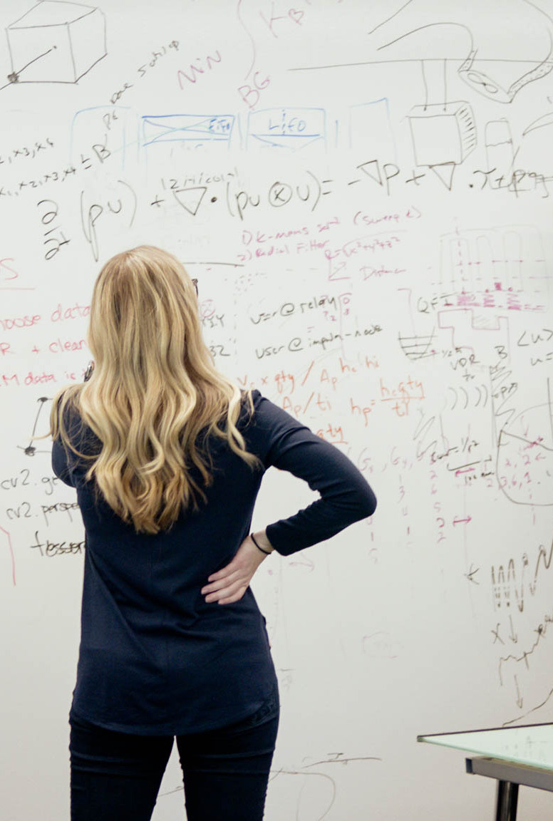Woman looking at data on a whiteboard