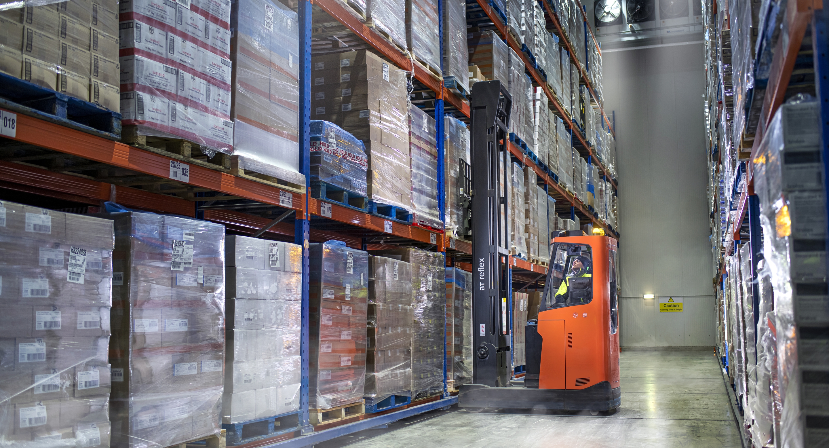 Forklift between shelves in a Lineage cold storage warehouse