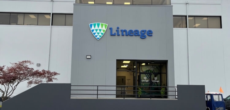 Front entrance of Lineage Seattle-Garfield facility with the company logo and a well-lit modern facade under a cloudy sky.