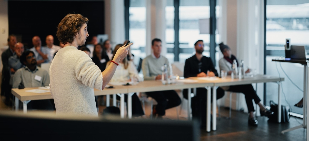 A young man presents his idea before a panel of judges at Lineage's 2023 Hackathon event, the precursor to the Food Chain Innovation Challenge