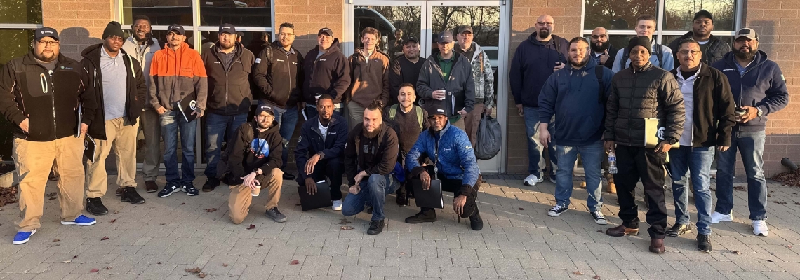 Group photo of Cohort 3 participants in the Lineage EDGE Program, gathered outdoors in front of a building, showcasing teamwork and leadership growth.