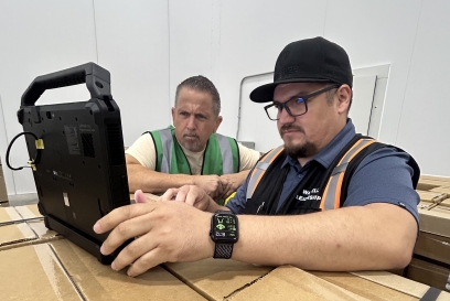 Two men looking at a laptop